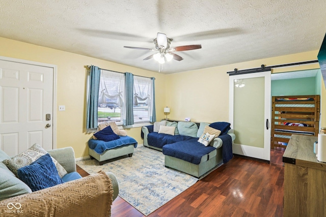 121 Apple St, Greenfield, IN 46140 - living room featuring a barn door, a ceiling fan, wood finished floors, and a textured ceiling