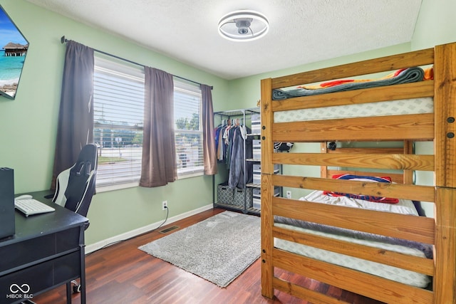 121 Apple St, Greenfield, IN 46140 - bedroom with wood finished floors, an office area, and a textured ceiling