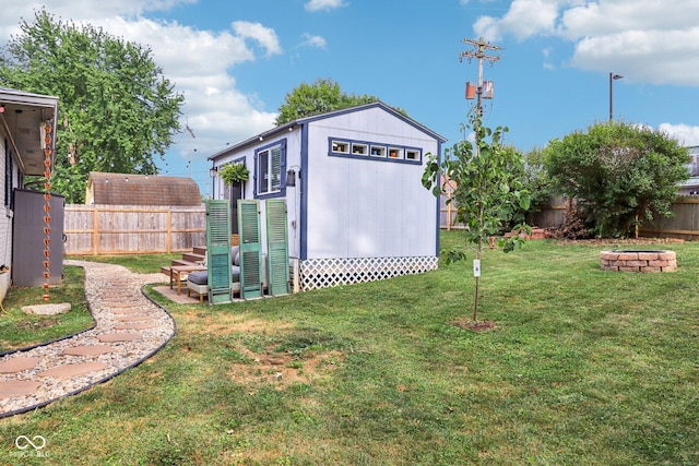 121 Apple St, Greenfield, IN 46140 - view of shed featuring a fenced backyard and a fire pit