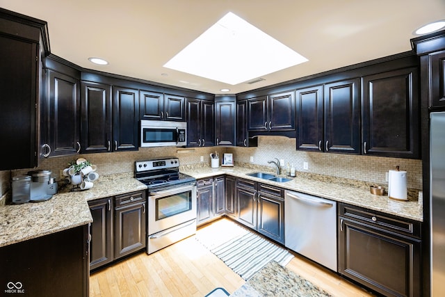20971 Shoreline Ct Unit 408, Noblesville, IN 46062 - kitchen with appliances with stainless steel finishes, light wood-style floors, and tasteful backsplash