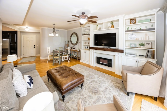 20971 Shoreline Ct Unit 408, Noblesville, IN 46062 - living room featuring a ceiling fan, ornamental molding, light wood-type flooring, and a fireplace