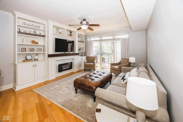 20971 Shoreline Ct Unit 408, Noblesville, IN 46062 - living room featuring a glass covered fireplace, a ceiling fan, light wood-style floors, and ornamental molding