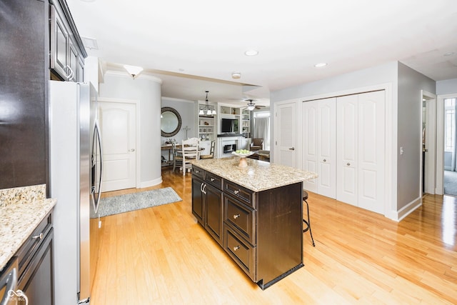 20971 Shoreline Ct Unit 408, Noblesville, IN 46062 - kitchen with stainless steel refrigerator with ice dispenser, a kitchen breakfast bar, ceiling fan, light wood-style floors, and recessed lighting