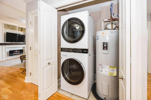20971 Shoreline Ct Unit 408, Noblesville, IN 46062 - washroom featuring stacked washer / dryer, electric water heater, and light wood finished floors