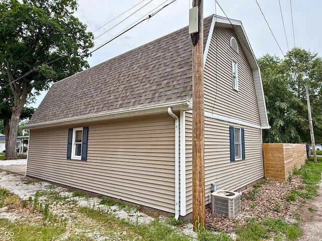 416 6th St, Covington, IN 47932 - view of side of home with roof with shingles and a cooling unit