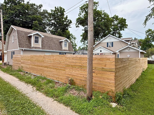 416 6th St, Covington, IN 47932 - view of side of home with roof with shingles and a gambrel roof