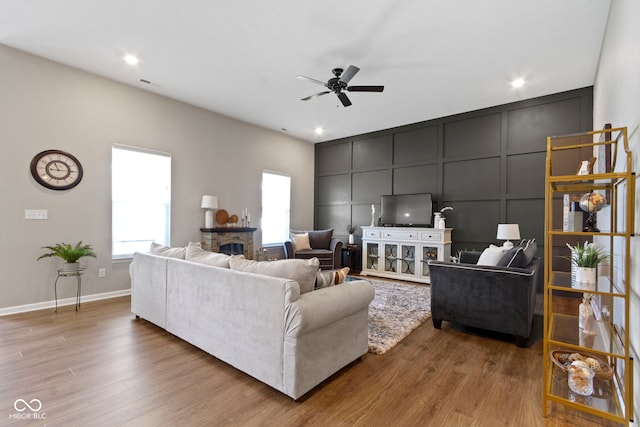 9801 Zion Way, Pendleton, IN 46064 - living room featuring a decorative wall, a ceiling fan, wood finished floors, and recessed lighting