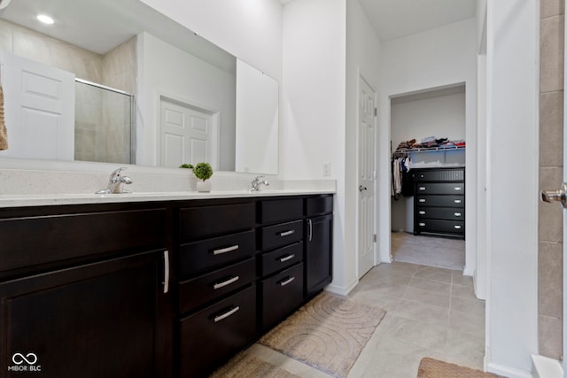 9801 Zion Way, Pendleton, IN 46064 - full bath with double vanity, tiled shower, a walk in closet, and tile patterned floors
