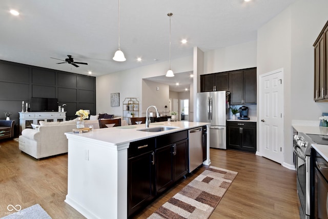 9801 Zion Way, Pendleton, IN 46064 - kitchen featuring stainless steel appliances, light wood-type flooring, light countertops, a ceiling fan, and a center island with sink