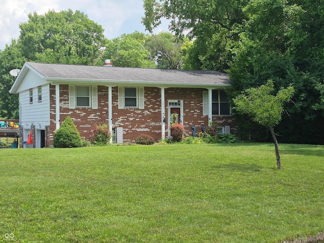 7802 Fall Creek Rd, Indianapolis, IN 46256 - split foyer home with brick siding, a front yard, and roof with shingles