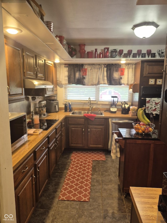 7802 Fall Creek Rd, Indianapolis, IN 46256 - kitchen with appliances with stainless steel finishes, under cabinet range hood, and wooden counters