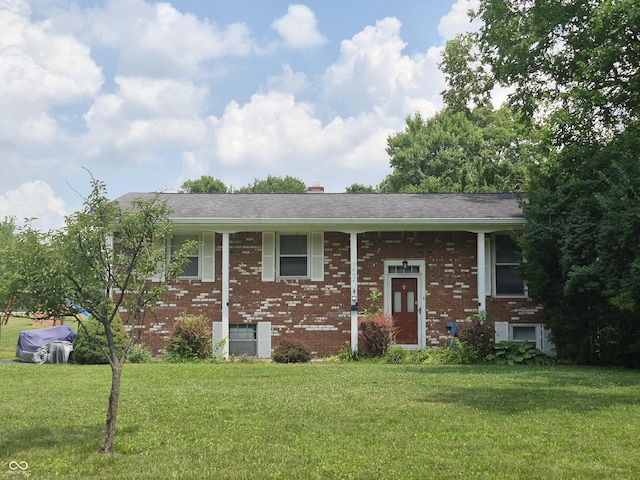 7802 Fall Creek Rd, Indianapolis, IN 46256 - bi-level home featuring brick siding, a front yard, and a chimney
