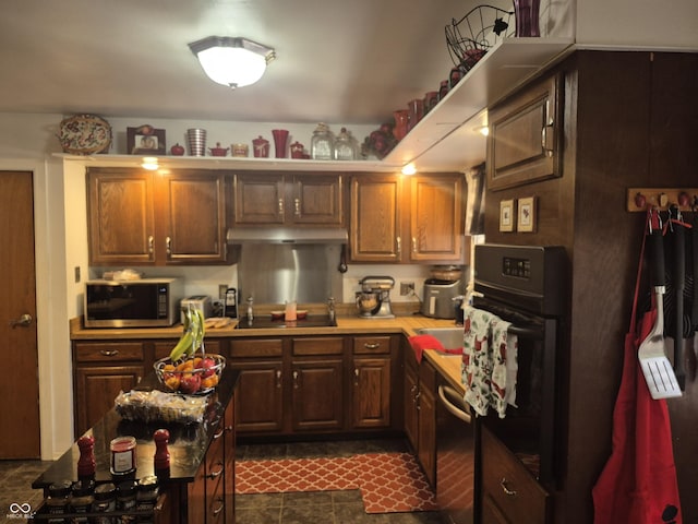 7802 Fall Creek Rd, Indianapolis, IN 46256 - kitchen featuring black appliances, under cabinet range hood, and light countertops