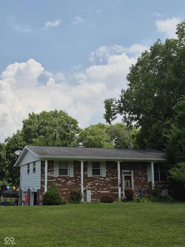 7802 Fall Creek Rd, Indianapolis, IN 46256 - raised ranch featuring a front yard and brick siding