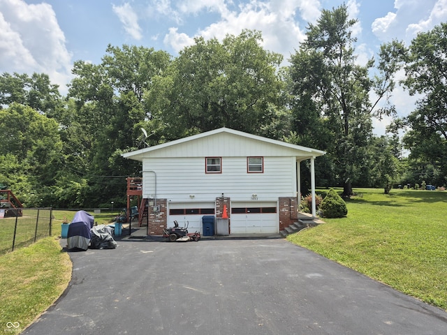 7802 Fall Creek Rd, Indianapolis, IN 46256 - view of property exterior featuring stairs, driveway, a garage, brick siding, and view of wooded area