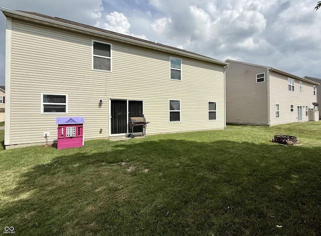 5020 Long Iron Dr, Indianapolis, IN 46235 - rear view of property featuring a lawn and a fire pit