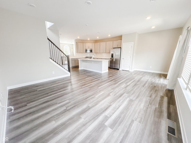 3522 Brampton Ln, Westfield, IN 46074 - unfurnished living room with light wood-style floors, recessed lighting, and stairs