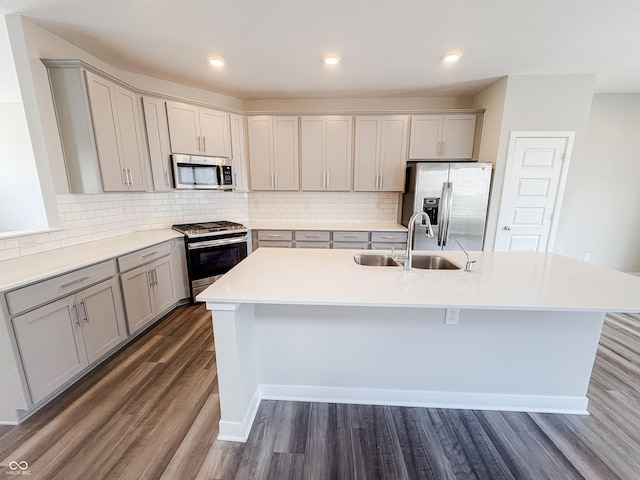 3522 Brampton Ln, Westfield, IN 46074 - kitchen featuring appliances with stainless steel finishes, gray cabinetry, dark wood finished floors, an island with sink, and recessed lighting
