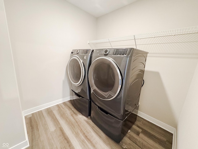 3522 Brampton Ln, Westfield, IN 46074 - laundry room featuring washing machine and dryer and light wood finished floors