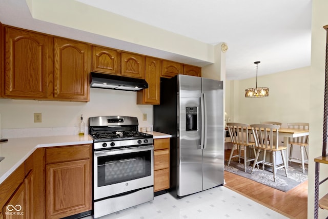 5034 Aspen Crest Ln, Indianapolis, IN 46254 - kitchen featuring stainless steel appliances, under cabinet range hood, brown cabinetry, and light flooring