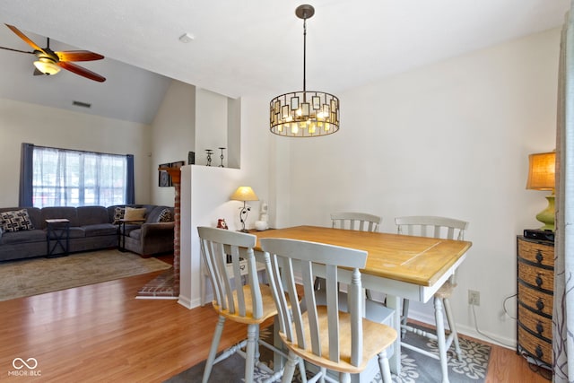 5034 Aspen Crest Ln, Indianapolis, IN 46254 - dining space with ceiling fan, wood finished floors, lofted ceiling, and a chandelier