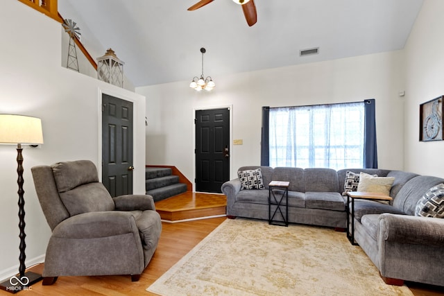 5034 Aspen Crest Ln, Indianapolis, IN 46254 - living room featuring wood finished floors, a ceiling fan, stairs, high vaulted ceiling, and a chandelier
