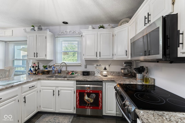 10532 Beacon Ln, Indianapolis, IN 46256 - kitchen with dishwasher, stainless steel microwave, electric stove, white cabinets, and a textured ceiling