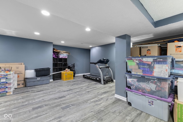 10532 Beacon Ln, Indianapolis, IN 46256 - workout area featuring wood finished floors, a textured ceiling, and recessed lighting