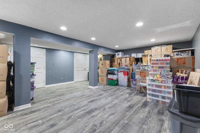 10532 Beacon Ln, Indianapolis, IN 46256 - basement with wood finished floors, a textured ceiling, and recessed lighting