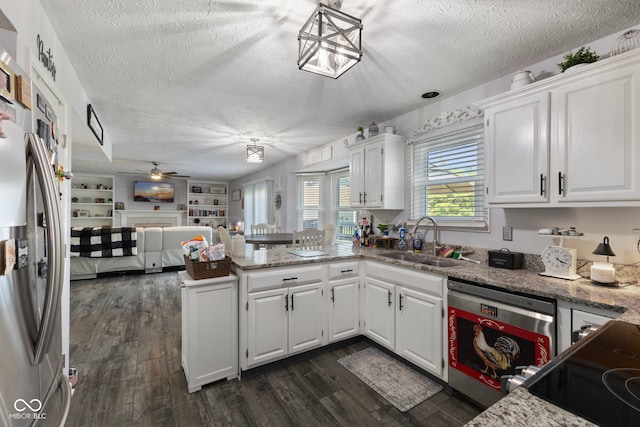 10532 Beacon Ln, Indianapolis, IN 46256 - kitchen featuring dishwasher, freestanding refrigerator, a textured ceiling, a peninsula, and a ceiling fan