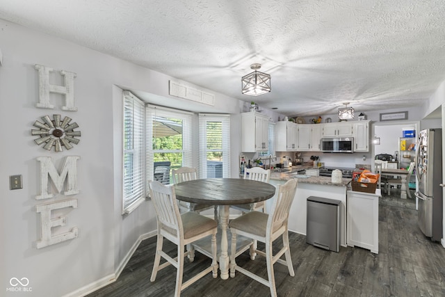 10532 Beacon Ln, Indianapolis, IN 46256 - dining area with a textured ceiling and dark wood finished floors