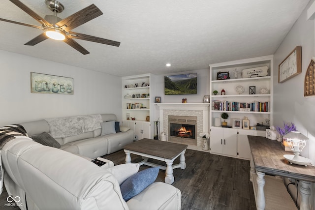 10532 Beacon Ln, Indianapolis, IN 46256 - living area featuring dark wood finished floors, ceiling fan, a brick fireplace, a textured ceiling, and recessed lighting