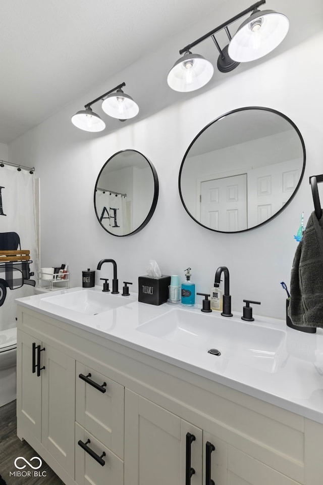 10532 Beacon Ln, Indianapolis, IN 46256 - full bathroom with double vanity and wood finished floors