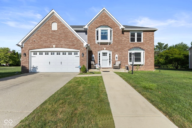 10532 Beacon Ln, Indianapolis, IN 46256 - view of front of property with a front lawn, driveway, brick siding, and an attached garage