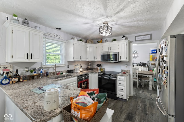 10532 Beacon Ln, Indianapolis, IN 46256 - kitchen featuring appliances with stainless steel finishes, dark wood-type flooring, a peninsula, a textured ceiling, and white cabinetry