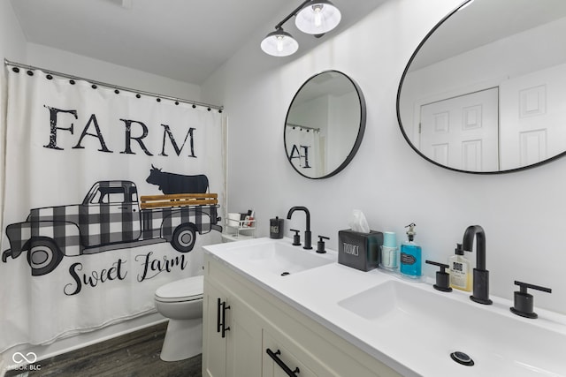 10532 Beacon Ln, Indianapolis, IN 46256 - full bathroom with double vanity, wood finished floors, and a shower with shower curtain