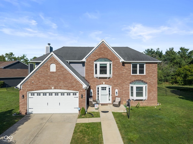 10532 Beacon Ln, Indianapolis, IN 46256 - view of front of home with concrete driveway, an attached garage, and brick siding