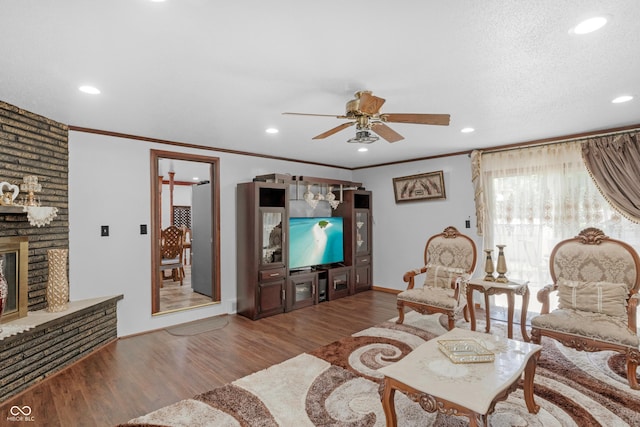 157 E Hill Valley Dr, Indianapolis, IN 46227 - living room featuring a ceiling fan, a brick fireplace, wood finished floors, crown molding, and recessed lighting