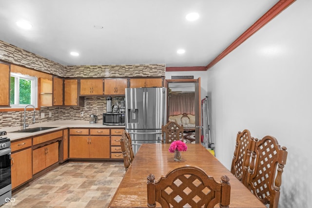 157 E Hill Valley Dr, Indianapolis, IN 46227 - kitchen with stainless steel appliances, light countertops, decorative backsplash, recessed lighting, and brown cabinetry
