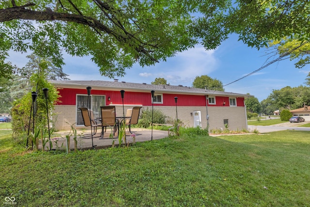 157 E Hill Valley Dr, Indianapolis, IN 46227 - rear view of property with brick siding, a patio area, and a lawn