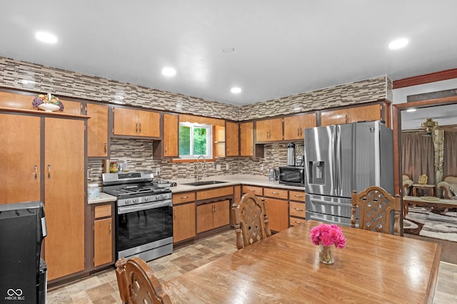 157 E Hill Valley Dr, Indianapolis, IN 46227 - kitchen featuring stainless steel appliances, light countertops, decorative backsplash, brown cabinetry, and recessed lighting