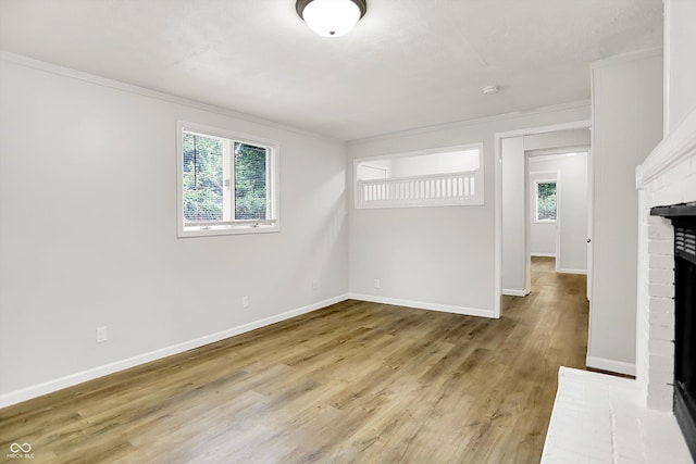 1065 Chevy Chase Ln, Carmel, IN 46280 - unfurnished room with healthy amount of natural light, a fireplace, ornamental molding, and light wood-style flooring