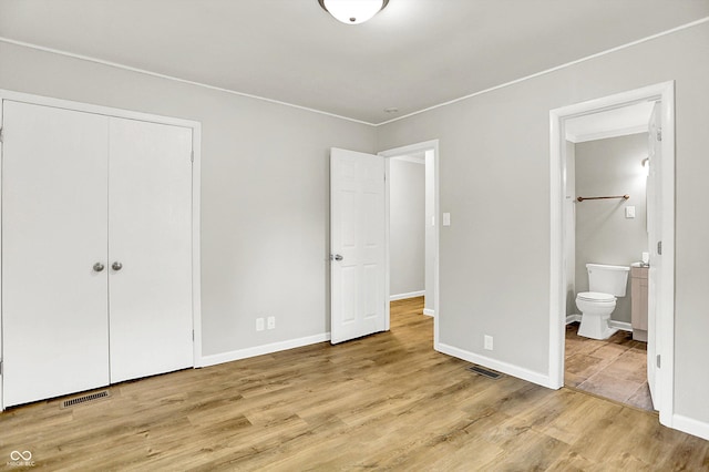 1065 Chevy Chase Ln, Carmel, IN 46280 - unfurnished bedroom with wood finished floors, ensuite bathroom, and a closet