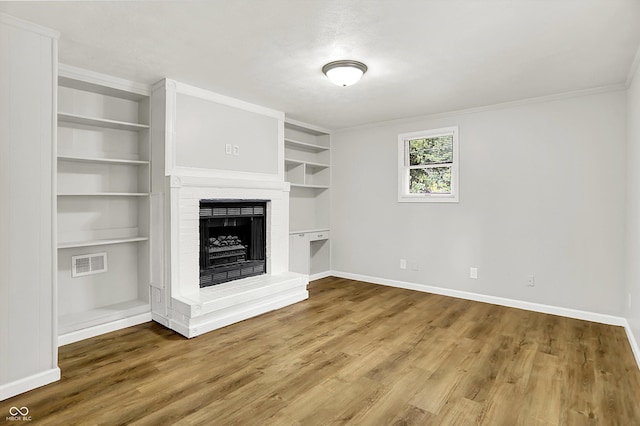 1065 Chevy Chase Ln, Carmel, IN 46280 - unfurnished living room with built in features, wood finished floors, a brick fireplace, and crown molding