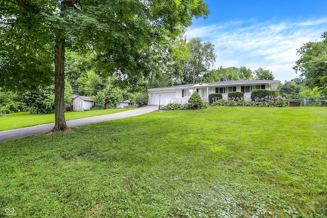 1065 Chevy Chase Ln, Carmel, IN 46280 - ranch-style home with concrete driveway, an attached garage, and a storage unit