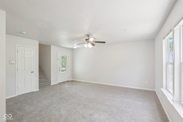 2629 Redland Ln, Indianapolis, IN 46217 - carpeted spare room with a ceiling fan, stairs, and a textured ceiling