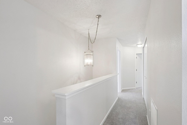 2629 Redland Ln, Indianapolis, IN 46217 - corridor with an upstairs landing, carpet, and a textured ceiling