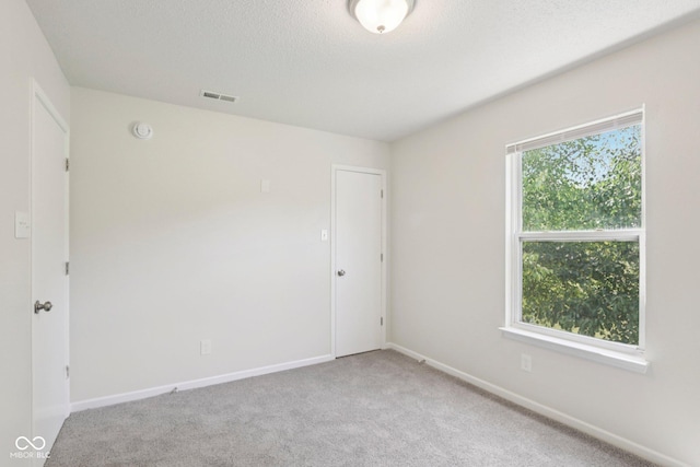 2629 Redland Ln, Indianapolis, IN 46217 - carpeted spare room with a smoke detector and a textured ceiling