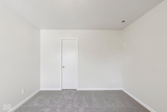2629 Redland Ln, Indianapolis, IN 46217 - carpeted empty room featuring baseboards and a textured ceiling