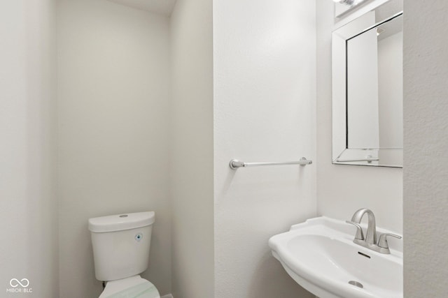 2629 Redland Ln, Indianapolis, IN 46217 - half bathroom featuring a sink and toilet